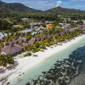 Aerial view of La Digue Island Lodge chalets and gardens along the beach at Anse Réunion, La Digue