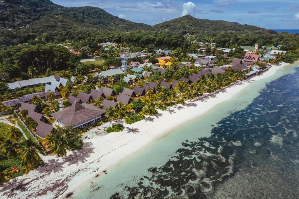 Aerial view of La Digue Island Lodge chalets and gardens along the beach at Anse Réunion, La Digue